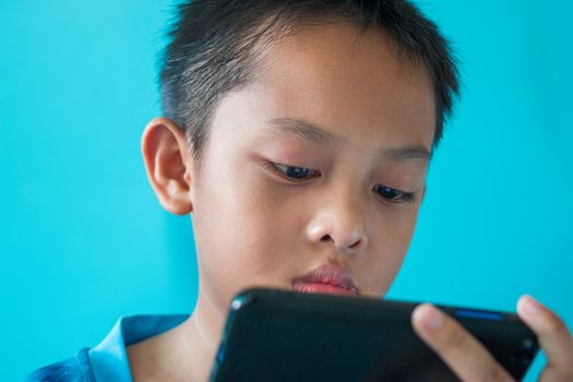 The boy is reading the corona virus news on his smartphone.