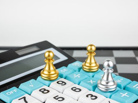 Financial games concept, Game of chess with calculator, selective focus.