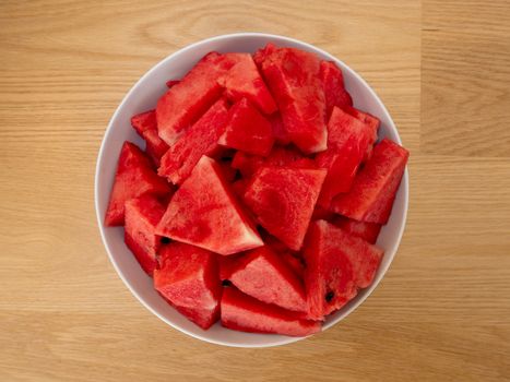 Cube slices of a ripe watermelon on a plate. Selective focus.