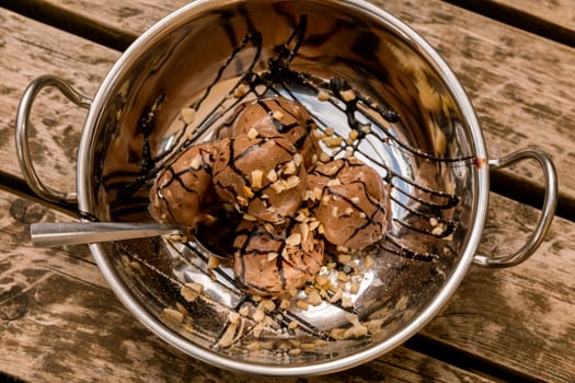 Chocolate ice cream in a silver bowl