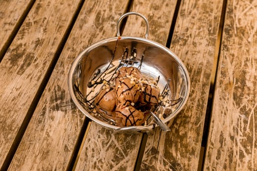 Chocolate ice cream in a silver bowl