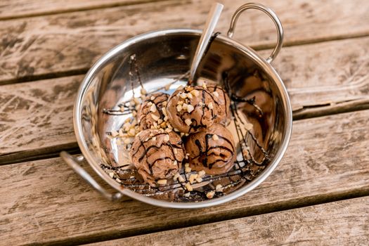 Chocolate ice cream in a silver bowl