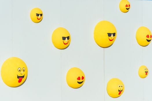 Wall bubble yellow emojis or emoticons for a street festival. Happiness, valentine's day, and joy concpets.