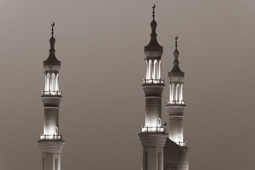 Islamic mosque spires in black and white echos prayer calls at night. Muslim, ramadan, religion concepts.