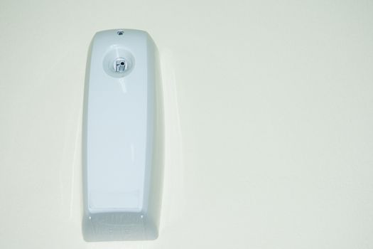 aromatic odor spray dispenser on the wall on a timer to add fragrance in the house or office