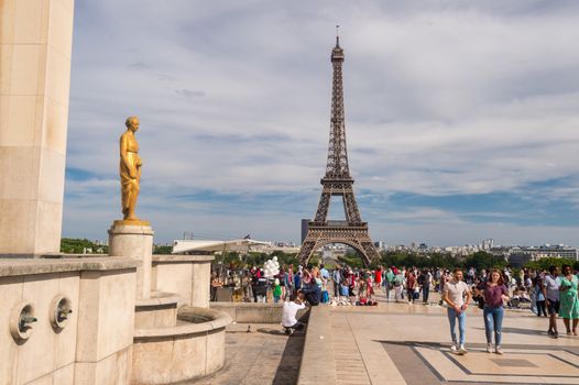 Paris, France - 23 June 2018: Eiffel Tower from Trocadero with many tourists in the foreground