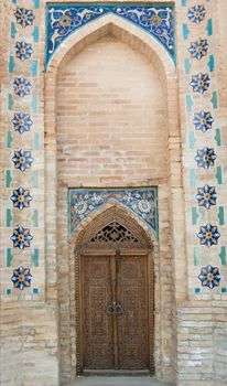 Wooden door with ancient Asian traditional ornament. the details of the architecture of medieval Central Asia