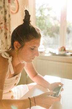 Young woman playing online games on a mobile phone