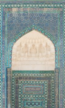 Wall with an arch and the dome in traditional Asian mosaic. the details of the architecture of medieval Central Asia