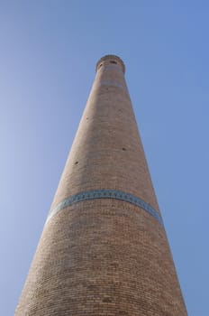 The view from the bottom up. High tower quite ancient Asian buildings. the details of the architecture of medieval Central Asia