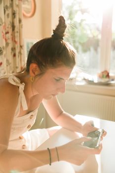 Young woman playing online games on a mobile phone