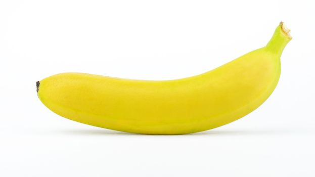 One ripe yellow banana isolated on a white background.