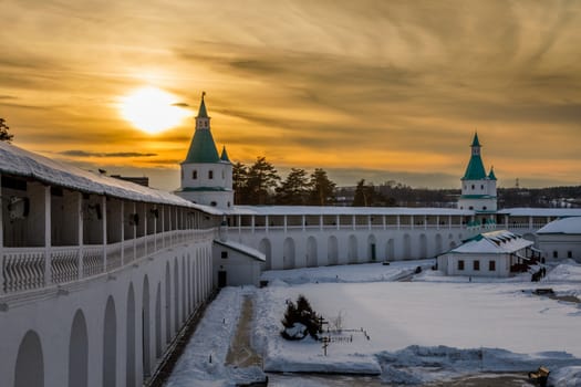 White walls, green towers and inner yard of New Jerusalem Monastery in sunset lights, Istra, Moscow region, Russia