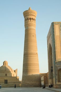 People near a high tower in the Eastern country. the ancient buildings of medieval Asia