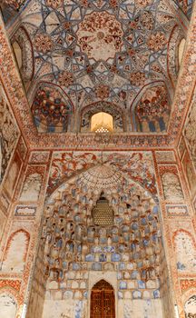 The ceiling in the form of a dome in a traditional ancient Asian mosaic. The details of the architecture of medieval Central Asia