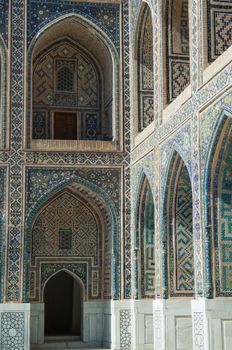 The arch and the exterior design of the ancient Registan in Samarkand. Ancient architecture of Central Asia