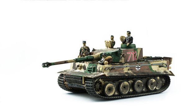 Old toy. Military tank with soldiers. Isolated on a white background.