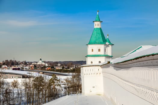 Fortified walls and white towers with green roof, winter landscape, New Jerusalem Monastery , Istra, Moscow region, Russia