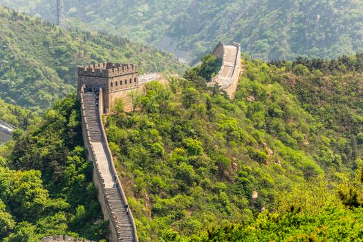 Panorama of Great Wall of China among the green hills and mountains near Beijing, China