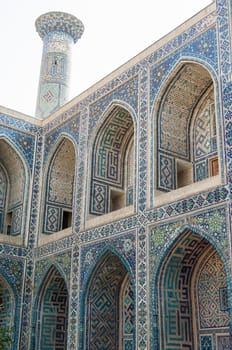 The arch and the exterior design of the ancient Registan in Samarkand. Ancient architecture of Central Asia