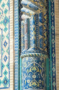 Fragment of a column in the wall with the mosaic. the details of the architecture of medieval Central Asia