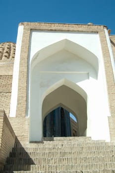 The arch and steps, the exterior design of the ancient Registan in Samarkand. Ancient architecture of Central Asia. Ancient architecture of Central Asia