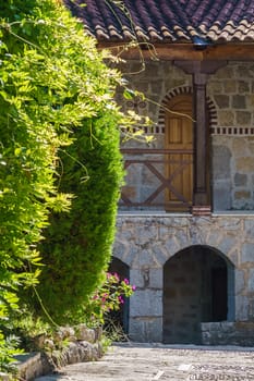 Mediterranean architecture. High vaulted doors in the stone wall of an old building.