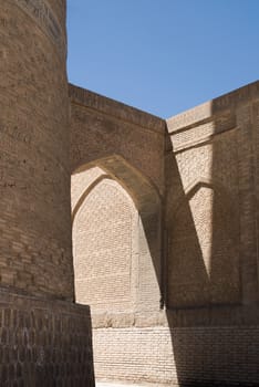 Old building with arch and passage. The ancient buildings of medieval Asia. Bukhara, Uzbekistan