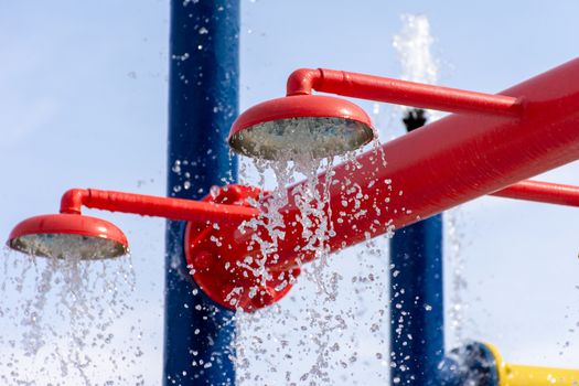 Summertime fun for the kids at the splash pad to play with water falling from bright colored fountains.