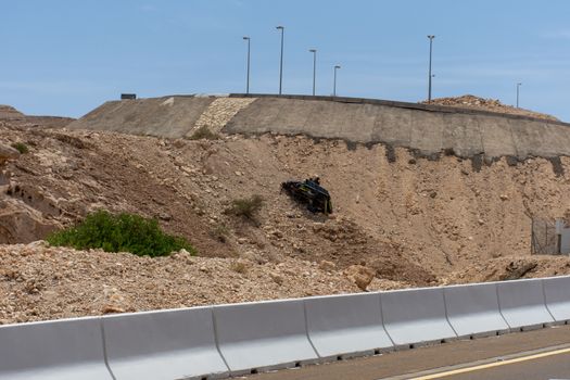 "Al Ain, Abu Dhabi/United Arab Emirates - 4/42019: A mountain highway truck crash or accident falling over the cliff of a dangerous road up Jebal Hafeet in Al Ain, United Arab Emirates (UAE)."
