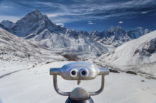 Public binoculars in front of a view over mountain peaks in the Everest Region, Nepal montage).