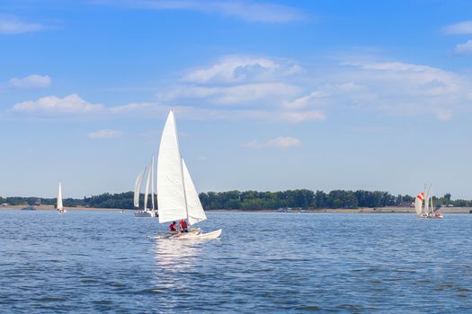 Competition among yachts with sails on the water of the Volga River