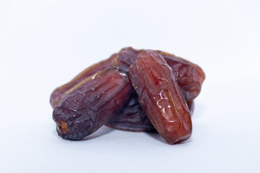 A group of medjool dates from Saudi Arabia on an isolated white background for Ramadan.