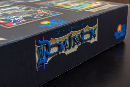 "RAK, RAK, UAE - 4/20/2019 : Side logo View of colourful deck building card game of Dominion the Big Box. Family fun for strategizing and having fun with this Rio Grande Games classic."
