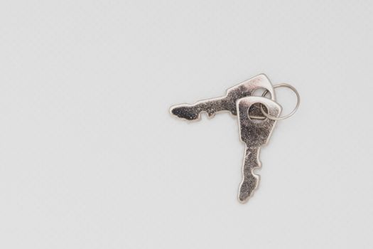 Two keys isolated on a white background spread out. Open space and concept.