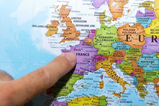 "RAK, RAK/UAE - 5/19/2019: Finger pointing to a colorful country map of Paris, France in Europe"