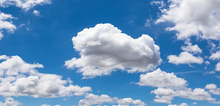 Panoramic white fluffy clouds in the blue sky, Fantastic soft white clouds against blue sky