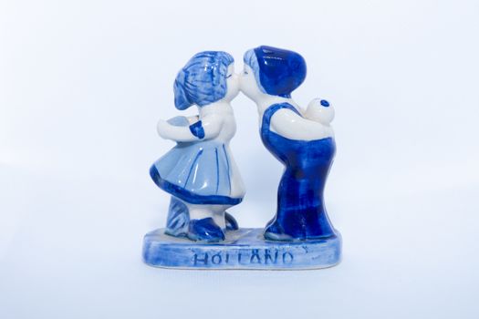 Delft Blue Figurine of kissing Dutch couple. Souvenier from Holland/Netherlands. Isolated on white background.