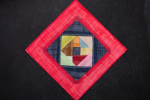 Geometric flat lay black background,  vivid colors of pink and red triangle shapes. Open concept.