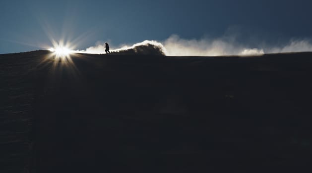 Skier enjoying an early morning in slopes at the Austrian Alps with a nice sunshine backlight