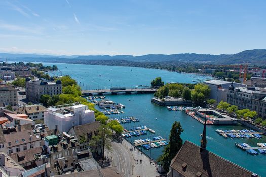 Zuichsee view from above in Zurich, Switzerland with Wasserkirche, mountains and river in view.