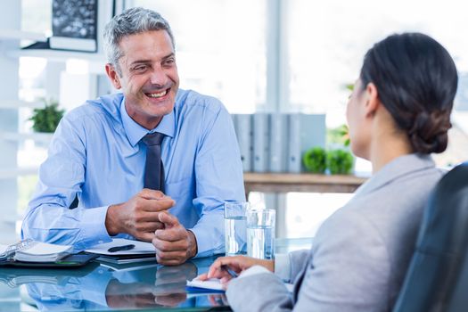 Happy business people speaking together in office