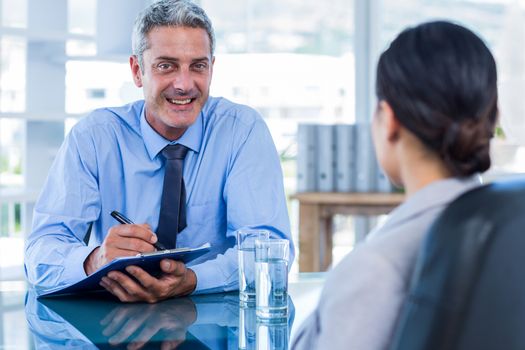 Happy business people speaking together in office