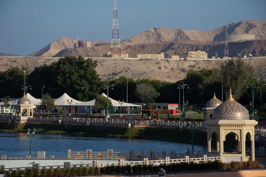 Qurm Park in Muscat, Oman in the evening looking at the lake and mountains on a quiet winter day.