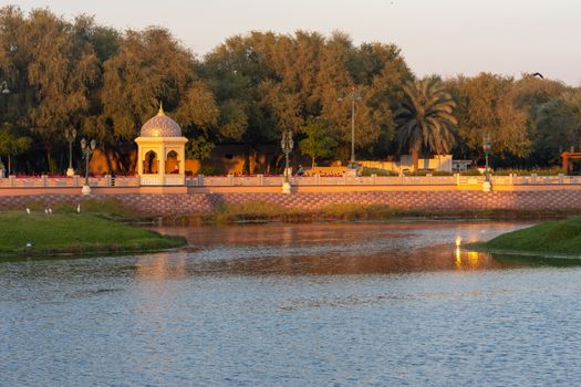 Qurm Park in Muscat, Oman in the evening looking at the lake and mountains on a quiet winter day.