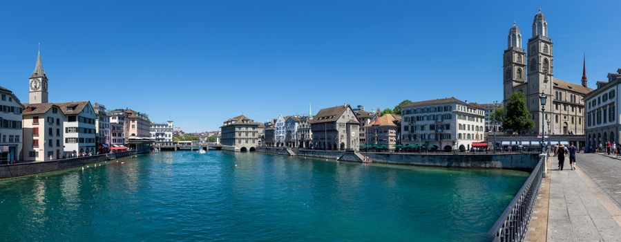 Street View of Downtown Zurich, Switzerland with old buildings, catherdrals and the river in view.