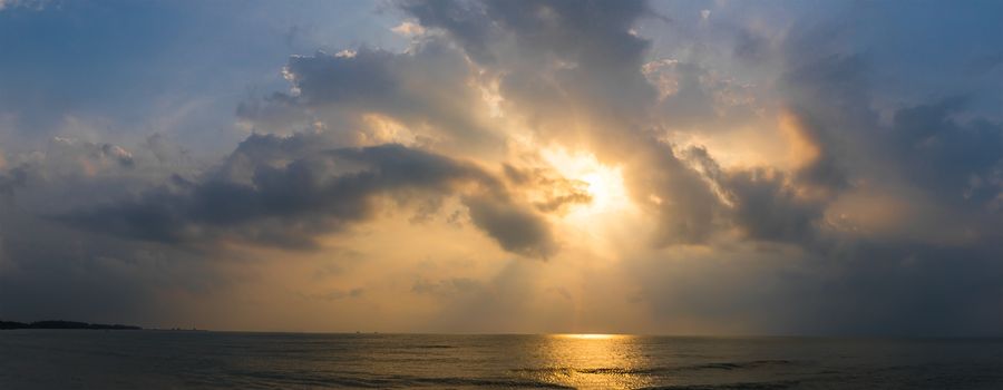 Panoramic sunset with fluffy clouds in the twilight sky,Sunlight with dramatic cloud over sea