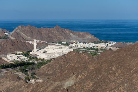 Al Bustan Palace near Old Town, Muscat in Oman looking down from mountains panning across the spectacular scene looking towards the water.