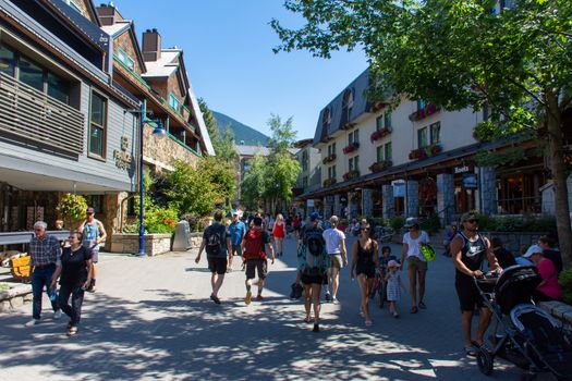"Whistler, British Columbia/Canada - 08/07/2019: Whistler village streets during the summer looking at the walkway, street, shops and tourists enjoying this Olympic world class destination."
