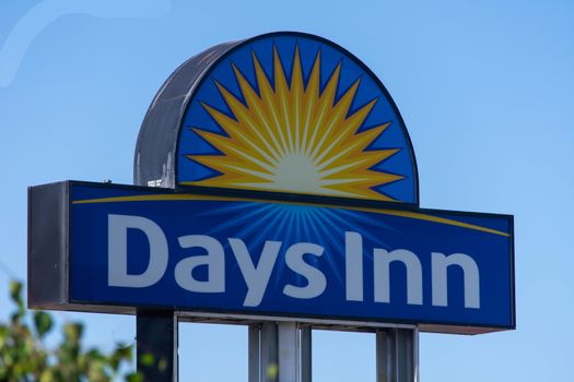 "Kelowna, British Columbia/Canada - 07/29/2019:  Close up of Days Inn  Hotel Sign on blue sky sunny day with copy space."